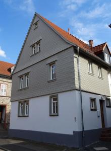 a white house with a gray roof at Das Schindelhaus in Groß-Umstadt