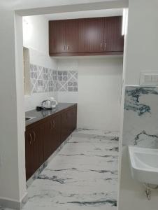 a bathroom with a sink and a toilet and a counter at Variyar Service Apartments Unit E 2nd Floor in Vellore