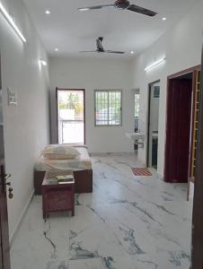 a large room with a bed and a table in it at Variyar Service Apartments Unit E 2nd Floor in Vellore