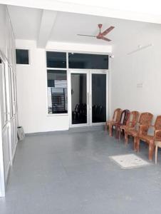 a room with chairs and a ceiling fan at Variyar Service Apartments Unit E 2nd Floor in Vellore