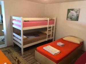 Habitación pequeña con 2 literas y mesa. en Guesthouse STAR en Mostar