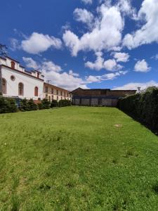 a large grassy field in front of a building at Hotel Silvia by Destino Pacifico in Silvia