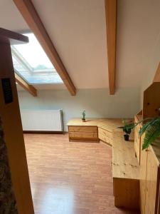 an attic room with a wooden desk and a window at Müllerstube in Neudorf bei Staatz