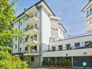 an exterior view of a white building with balconies at Villa Strandperle Whg 04 in Bansin