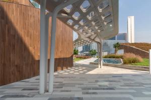 awning over a sidewalk in front of a building at Frank Porter - Index Tower in Dubai
