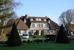 a house with a van parked in front of it at Golf Hotel in Le Tr&eacute;port