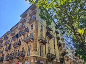 a tall building with balconies on the side of it at Ana's Place Torino 1 in Turin