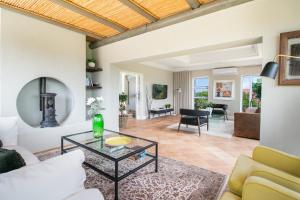 a living room with a couch and a table at BS1 - Pezula Exclusive Elegance in Knysna