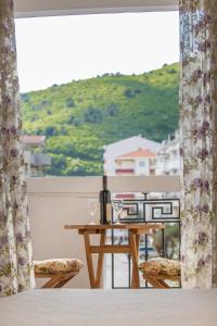 a table with a bottle of wine on a balcony at Hotel Villa Perla Di Mare in Budva