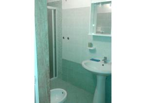 a bathroom with a sink and a shower and a toilet at Casa Giovanni by My Home Apulia in Torre Lapillo +16 photos