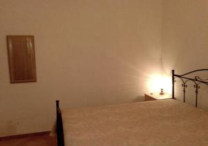 a bedroom with a bed with a light on it at Casa Giovanni by My Home Apulia in Torre Lapillo