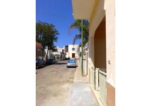 a car parked on a street next to a building at Casa Giovanni by My Home Apulia in Torre Lapillo