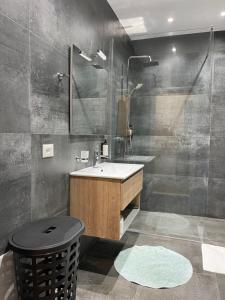 a bathroom with a sink and a shower at Port Side Sarande in Sarandë +28 photos
