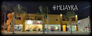 里奧哈的住宿－Edificio Huayra，一座楼前有棕榈树的商店