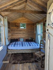 a bedroom with a bed in a log cabin at Shires Barns in Chippenham