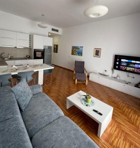 a living room with a couch and a table at Port Side Sarande in Sarandë