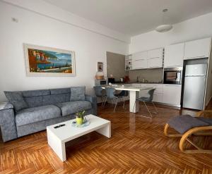 a living room with a couch and a table at Port Side Sarande in Sarandë
