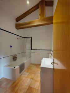 a bathroom with a bath tub and a sink at Casa da Queira in Ares