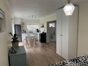 a room with a kitchen and a living room at Silver Sunsets Self-Catering Apartments in Cape Town