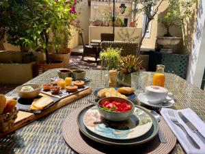 a table with a plate of food and a bowl of fruit at Palacio Ramalhete in Lisbon