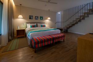 a bedroom with a bed and a stair case at Iguazu Jungle Lodge in Puerto Iguazú