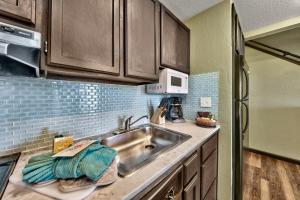 a kitchen with a sink and a microwave at Newly Remodeled Studio plus Loft- Lakeland Village condo in South Lake Tahoe