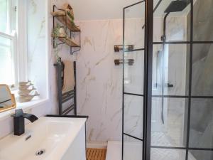 a bathroom with a shower and a sink at Windycroft in Barmouth +23 photos