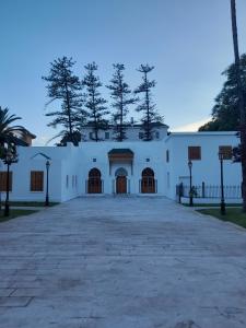 a large white building with a large driveway at story house salah in Rabat