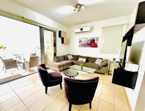 a living room with a couch and chairs at LARA 303 in Larnaca