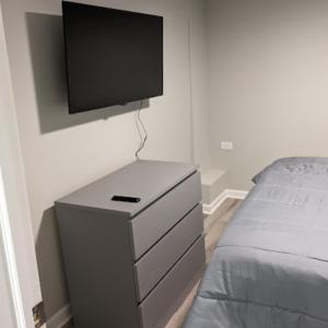 1 dormitorio con vestidor y TV en la pared en Modern 2 BDRM Apartment in Chicago en Chicago