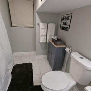 a white bathroom with a toilet and a sink at Fully Furnished Extended Stay Work or Insurance in Chicago in Chicago