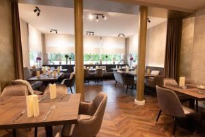 a restaurant with tables and chairs in a room at Hotel Restaurant Hackmann-Atter in Osnabrück
