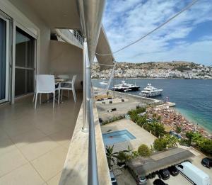 a balcony with a view of the water and boats at Port Side Sarande in Sarandë
