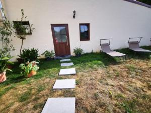 a yard with stepping stones in front of a house at Landhaus Messerschmitt in Böchingen