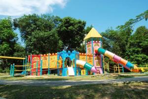 a playground in a park with a colorful play structure at Cozy Private Bunk Bed Room in Bayan Lepas