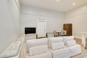 a living room with white chairs and a flat screen tv at Cozy Scranton Studio Rental Pets Welcome! in Scranton
