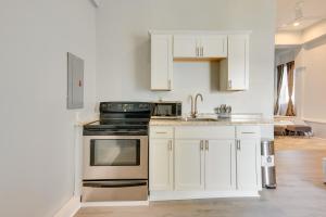 a kitchen with white cabinets and a stove top oven at Cozy Scranton Studio Rental Pets Welcome! in Scranton