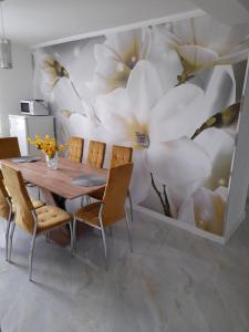 a dining room with a large flower mural on the wall at Apartmany Dianka in Veľký Slavkov