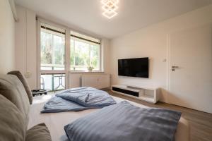 a living room with a couch and a flat screen tv at AR Rezidencia Fibichova in Košice