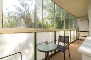 a room with a table and chairs and windows at AR Rezidencia Fibichova in Košice