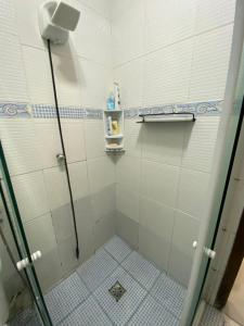 a bathroom with a shower with a tiled floor at valenshostel in Angra dos Reis