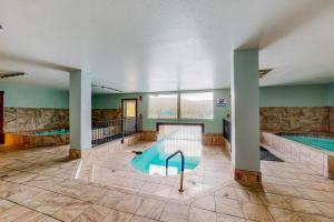 a large room with two swimming pools in it at Charming Pad in Granby