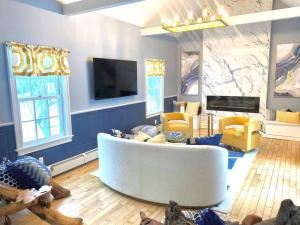 a living room with a white couch and yellow chairs at Luxury Farm Stay-Bonds Corner Bungalow-Wolf Pine Hollow in Hancock