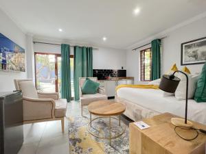 a bedroom with a large bed and a kitchen at Amoris Guesthouse - In Randburg in Johannesburg