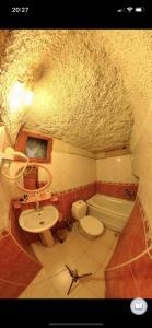a bathroom with a sink and a toilet and a sink at Monastery cave Hotel Cappadocia in Mustafapaşa +18 photos