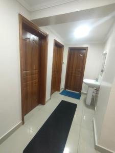 a bathroom with two wooden doors and a sink at Executive 3 bedroom in Nakuru CBD in Nakuru
