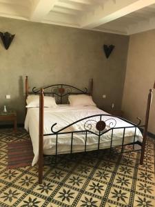 a bedroom with a large bed with white sheets at CHATEAU D'ORIENT in Essaouira