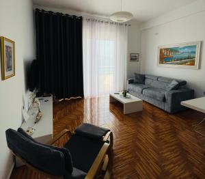 a living room with a couch and a table at Port Side Sarande in Sarandë