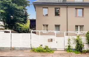 a white fence in front of a house at Awesome Home In Swinoujscie With Wifi in Świnoujście