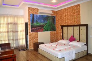 Chandiv Hotel tesisinde bir odada yatak veya yataklar